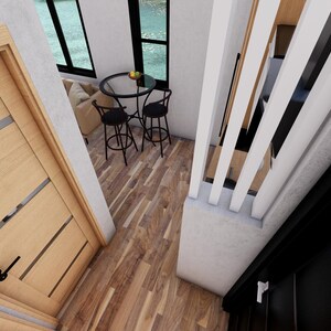 May include: Interior view of a modern home with a wooden door, hardwood floors, and a small table with two chairs. The space includes a staircase and a window overlooking an outdoor scene.