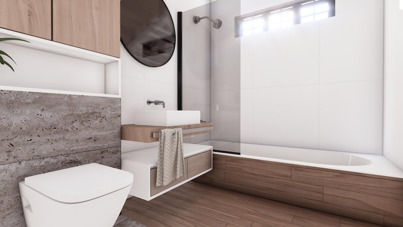 May include: Modern bathroom design featuring a white toilet, sink, and bathtub. The space includes wooden cabinets, a large round mirror, and a shower with a glass door. The walls are white with a stone accent.