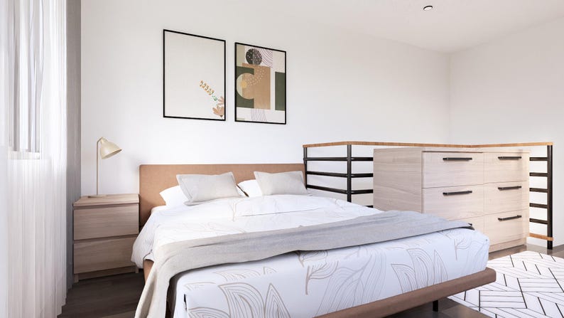 K&ouml;nnte beinhalten: Ein modernes Schlafzimmer mit einem Bett, Kissen und einer gemusterten Bettdecke. Ein Nachttisch mit einer Lampe steht neben dem Bett. Zwei gerahmte Kunstwerke schm&uuml;cken die Wand. Eine gro&szlig;e Kommode befindet sich im Hintergrund.