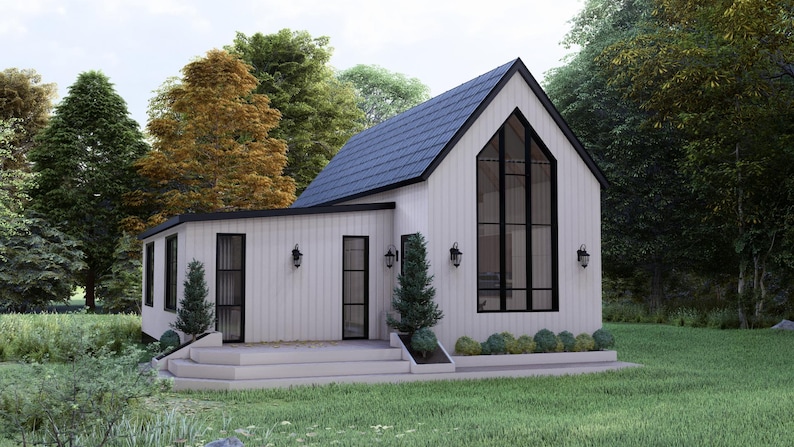 K&ouml;nnte beinhalten: Ein modernes wei&szlig;es Haus mit einem dunkelblauen Dach und schwarzen Fensterrahmen. Das Haus hat ein gro&szlig;es, bogenf&ouml;rmiges Fenster und ist von B&auml;umen und gr&uuml;nem Gras umgeben. Au&szlig;enleuchten sind an den W&auml;nden angebracht.