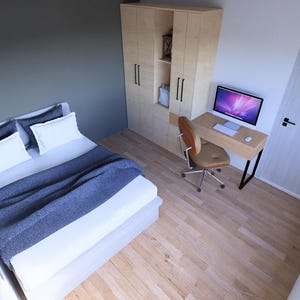 May include: A modern bedroom interior with a bed, desk, and wardrobe. The bed has white bedding and a blue blanket. A wooden desk with a computer and a brown chair are in the corner. A wooden wardrobe is also present.