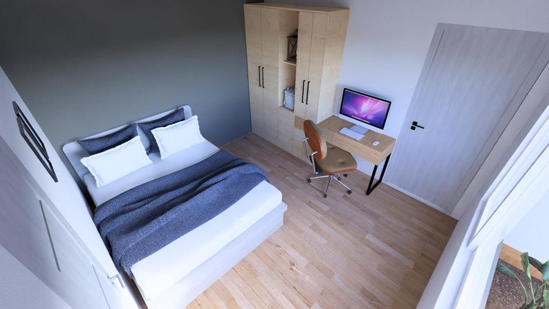 May include: A modern bedroom interior with a bed, desk, and wardrobe. The bed has white bedding and a blue blanket. A wooden desk with a computer and a brown chair are in the corner. A wooden wardrobe is also present.