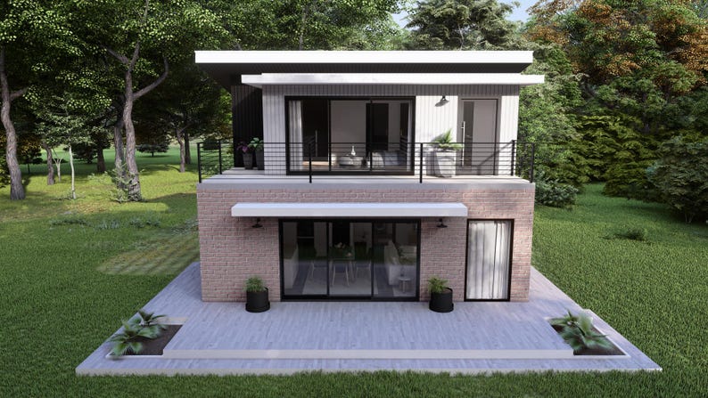 Op de afbeelding: Een modern huis met twee verdiepingen, een plat dak, een bakstenen gevel en grote glazen deuren en ramen. Het huis heeft een balkon met een zwarte balustrade en is omgeven door groen gras en bomen. Het huis heeft een lichtgrijze patio.