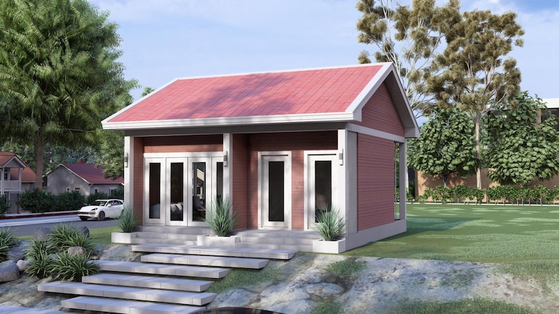 May include: A small, modern, red-sided house with a red roof and white trim. The house has multiple glass doors and windows, with a small porch and steps leading up to the entrance. Landscaping includes small plants and a green lawn.