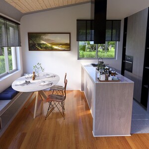 May include: Contemporary kitchen featuring a light wood floor and a white countertop island. A round dining table with two chairs is positioned near a window with blinds. A stainless steel fridge and built-in oven are also visible.