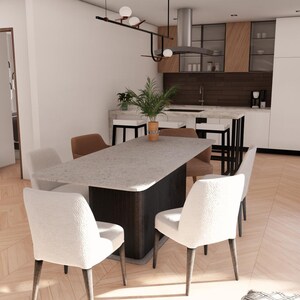 May include: A dining room featuring a rectangular stone-topped table with a dark base, surrounded by four white upholstered chairs and two brown chairs. The kitchen area includes white cabinetry, wood-toned accents, and a kitchen island with stools.