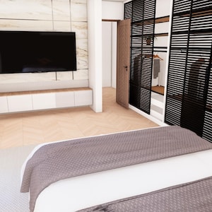 May include: A bedroom interior featuring a bed with a gray textured cover, a wall-mounted television above a white cabinet, and a walk-in closet with black slatted doors. The room has light wood flooring and a marble-patterned accent wall behind the TV.