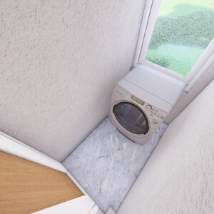 May include: A small, white washing machine is positioned in a corner near a window. The walls are textured and painted white. The floor is a light gray color. The window looks out onto a green, grassy area.
