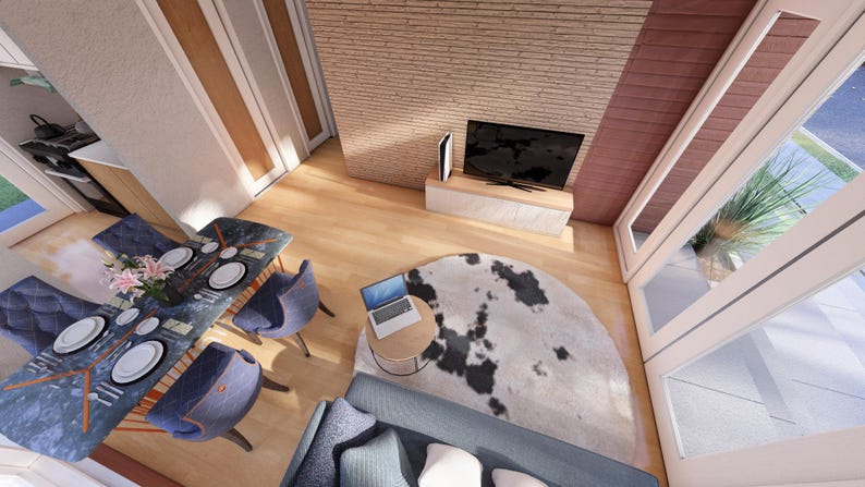 May include: An overhead view of a modern living space with a dining table set for a meal. The table is set with plates, silverware, and flowers. A cowhide rug sits on the floor, and a laptop is on a small table.