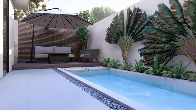 May include: A rectangular swimming pool with light blue water sits beside a wooden deck featuring a beige sofa, a dark coffee table, and a large cantilevered umbrella. A brick wall and large fan-shaped green plants line the patio area.