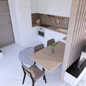 May include: An overhead view of a modern kitchen and dining area. The kitchen features white cabinets, a wooden countertop, and stainless steel appliances. A wooden table with four chairs sits in the dining area, with a decorative rug and a staircase in the background.