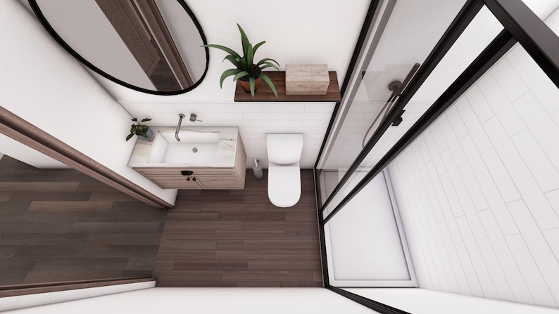 May include: An overhead view of a modern bathroom with a wooden floor and white walls. The bathroom features a sink, toilet, and a shower with a black frame. A mirror and a shelf with plants and a box are also visible.