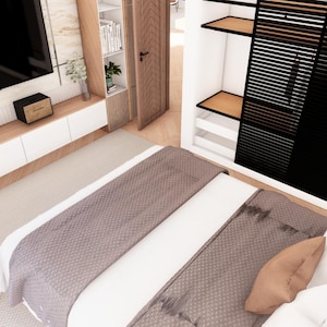 May include: A bedroom interior featuring a bed with a white duvet, a taupe textured throw blanket, and assorted pillows in taupe, white, and gray. A wall-mounted television sits above a white and light wood media console, next to a black slatted wardrobe.