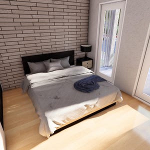 May include: A modern bedroom with a gray bedspread, pillows, and a dark headboard. A blue throw blanket rests on the bed. The room has a brick accent wall, a bedside table with a lamp, and a door leading to a balcony.