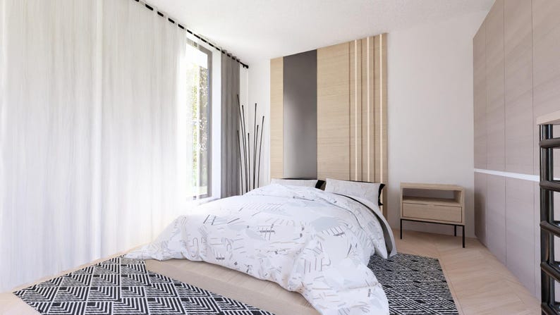 May include: A modern bedroom with a bed covered in a white and gray patterned comforter. The room features a large window with white curtains, a wooden headboard, a nightstand, and a patterned rug. The walls are painted white.
