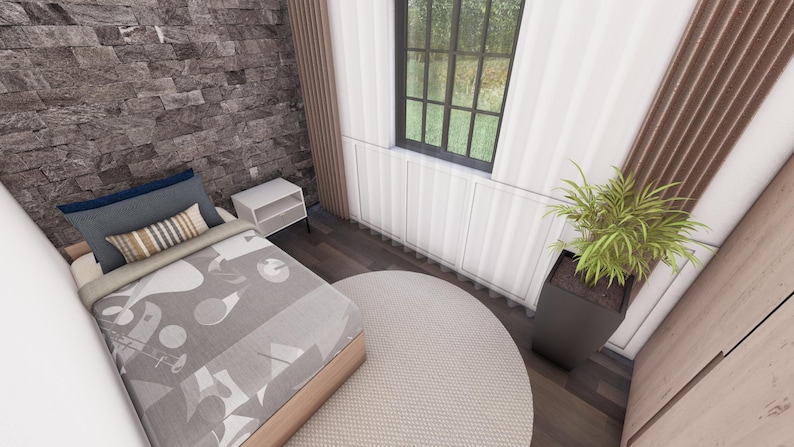 May include: Bedroom interior with a bed, pillows, and a patterned blanket. A round rug sits on the floor. A window with a view of the outside is visible. A potted plant is in the corner.