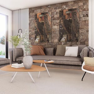 May include: A living room featuring a gray sofa with brown and white pillows, a gray ottoman, and a white lounge chair with a brown cushion. Two wooden coffee tables sit on a light rug, with a stone wall backdrop and modern vertical wall panels.