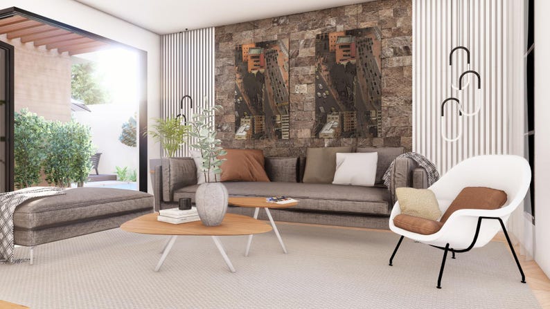 May include: A living room featuring a gray sofa with brown and white pillows, a gray ottoman, and a white lounge chair with a brown cushion. Two wooden coffee tables sit on a light rug, with a stone wall backdrop and modern vertical wall panels.