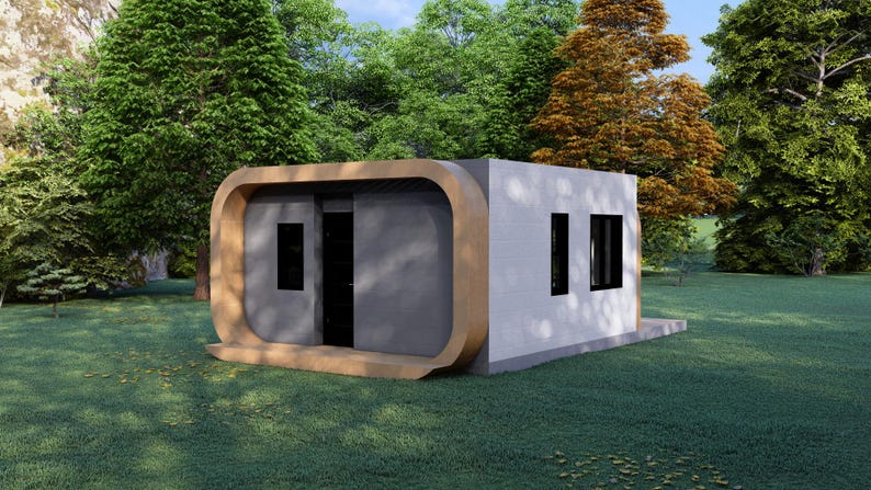May include: A modern, prefabricated tiny home with a unique design. The structure features a light gray exterior with a curved wooden frame and black windows and door. Set on a grassy lawn surrounded by trees.