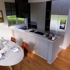 May include: Interior view of a contemporary kitchen and dining space. The kitchen has light wood cabinets, a stainless steel fridge, and a black extractor fan. A round dining table is set with plates and cutlery. The flooring is hardwood.