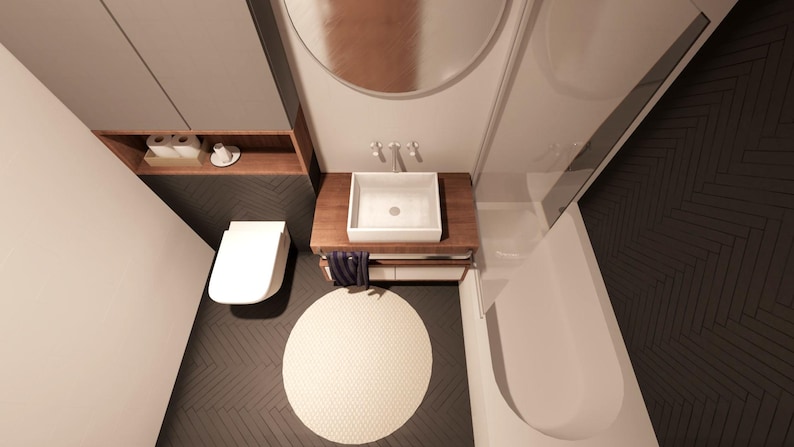 Peut inclure: Vue a&eacute;rienne d'une salle de bain moderne avec toilettes, lavabo et baignoire blancs. Le lavabo est pos&eacute; sur un meuble en bois. Un tapis rond cr&egrave;me est pos&eacute; sur le sol sombre &agrave; chevrons. Une &eacute;tag&egrave;re en bois contient des articles de toilette.