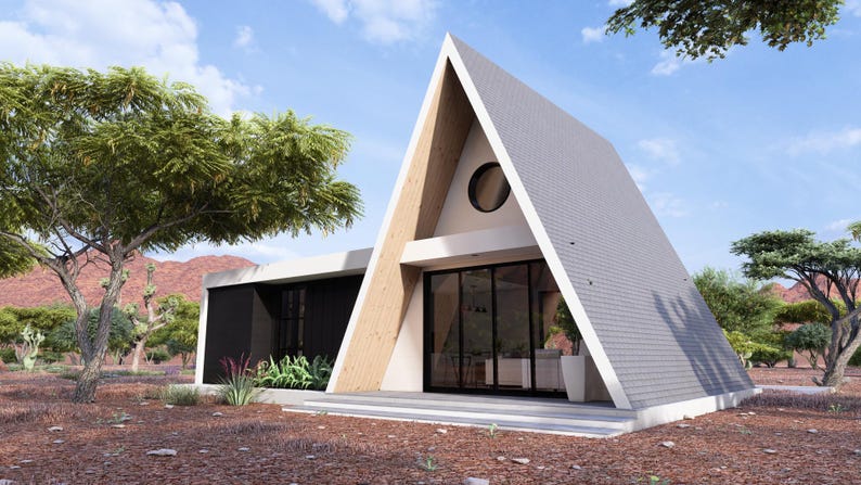 K&ouml;nnte beinhalten: A-f&ouml;rmiges Haus mit wei&szlig;em Dach und Holzakzenten. Das Haus hat eine gro&szlig;e Glast&uuml;r und ein rundes Fenster. Das Haus ist von B&auml;umen und einer Bergkette im Hintergrund umgeben. Das Haus ist ein modernes Design.