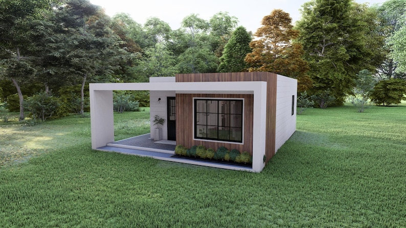 May include: A modern, minimalist house with a flat roof and a covered porch. The exterior features white walls, wood paneling, and a large window with black trim. The house is surrounded by green grass and trees.