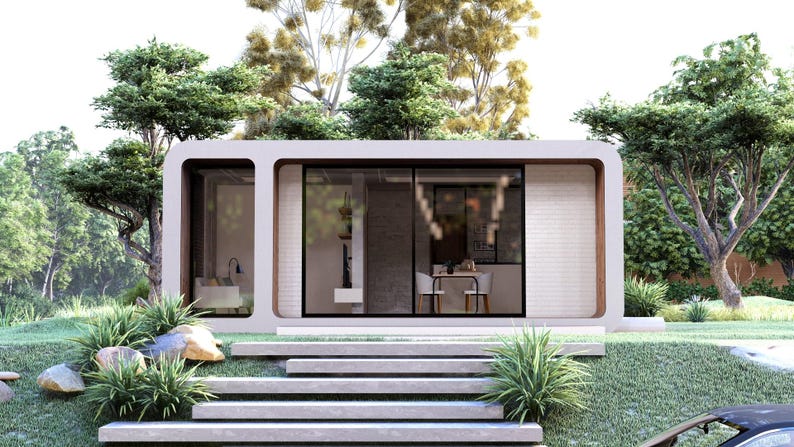 Peut inclure: Petite maison moderne et minimaliste avec un ext&eacute;rieur de couleur claire, de grandes fen&ecirc;tres et un toit plat. La maison est entour&eacute;e d'une verdure luxuriante, avec des arbres, des buissons et de l'herbe, et est accessible par des marches en b&eacute;ton.