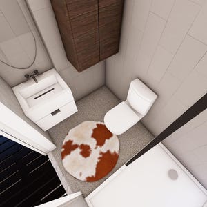 May include: An overhead view of a small bathroom with white walls and a gray floor. The bathroom includes a white toilet, a white sink with a cabinet, and a brown and white cowhide rug. A brown cabinet is mounted on the wall.