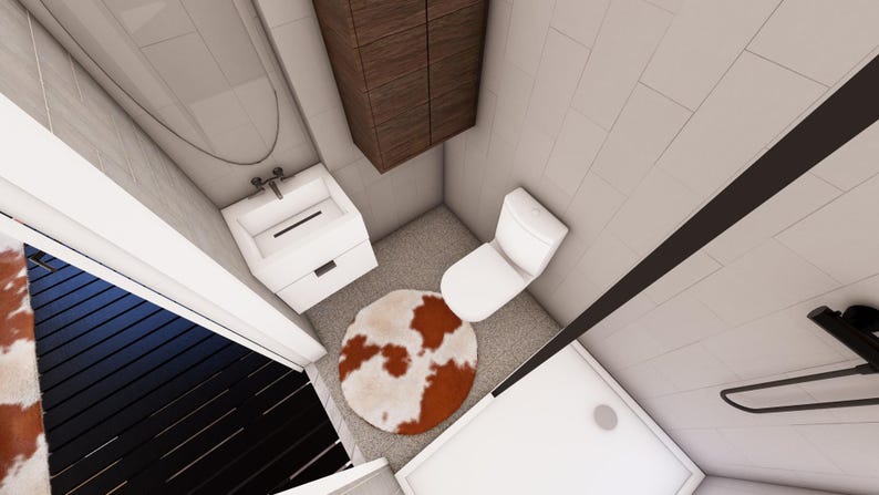 May include: An overhead view of a small bathroom with white walls and a gray floor. The bathroom includes a white toilet, a white sink with a cabinet, and a brown and white cowhide rug. A brown cabinet is mounted on the wall.