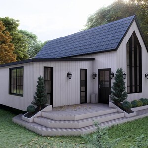 K&ouml;nnte beinhalten: Ein modernes wei&szlig;es Haus mit einem dunkelblauen Dach und schwarzen Fensterrahmen. Das Haus hat eine kleine Veranda mit Stufen, die zur Haust&uuml;r f&uuml;hren. Das Haus ist von B&auml;umen und Gras umgeben.