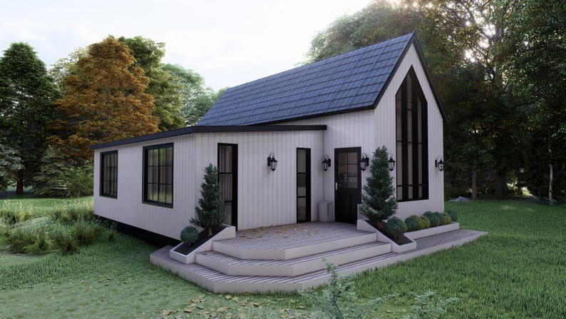 K&ouml;nnte beinhalten: Ein modernes wei&szlig;es Haus mit einem dunkelblauen Dach und schwarzen Fensterrahmen. Das Haus hat eine kleine Veranda mit Stufen, die zur Haust&uuml;r f&uuml;hren. Das Haus ist von B&auml;umen und Gras umgeben.