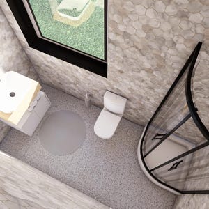 May include: An overhead view of a modern bathroom with a white toilet, sink, and shower. The walls and floor are covered in a light gray hexagonal tile. A round mirror and a window are also visible.