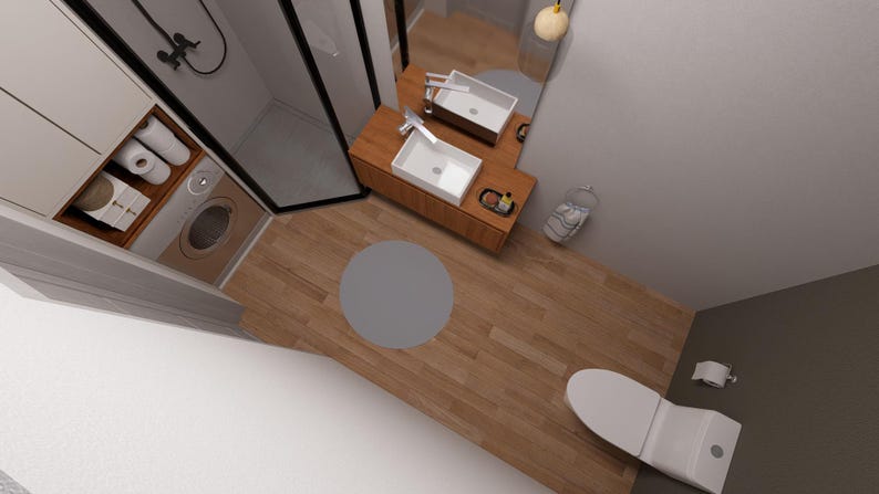 May include: An overhead view of a modern bathroom with a wooden floor. The room features a white toilet, a sink with a wooden vanity, a shower, and a washing machine. A gray circular rug is on the floor.