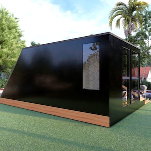May include: A modern, black, geometric structure with a wooden base and large windows. The building is set on a green lawn with trees and a road in the background. The structure has a slanted roof and a minimalist design.