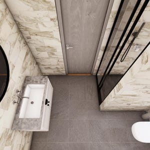 May include: An overhead view of a modern bathroom with marble-effect walls and grey tile flooring. Features include a large round mirror, a white sink with chrome fixtures, a shower enclosure, a toilet, and a wooden door.