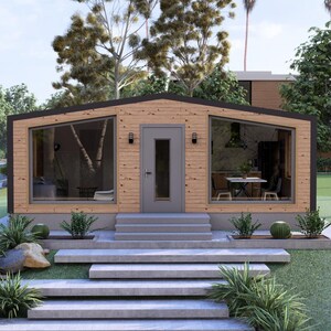 May include: A contemporary wooden house with large windows and a grey door. The house has a flat roof and is surrounded by greenery, including grass, bushes, and trees. Concrete steps lead up to the front door.