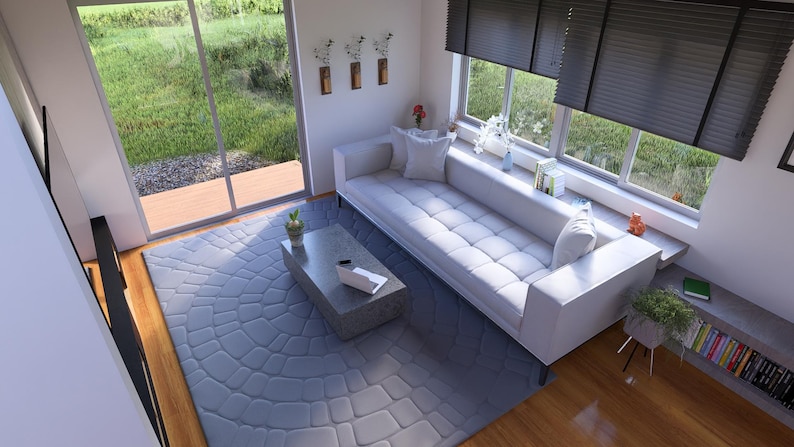May include: A contemporary living room featuring a white sofa, a grey coffee table, and a patterned rug. Large windows provide a view of the garden. The room is decorated with plants and books, creating a comfortable atmosphere.