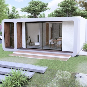Peut inclure: Une maison modulaire blanche moderne avec de grandes portes et fen&ecirc;tres vitr&eacute;es, situ&eacute;e sur une pelouse verte. La maison pr&eacute;sente un design minimaliste avec des accents en bois et un petit porche. L'am&eacute;nagement paysager comprend des marches en pierre et des plantes d&eacute;coratives.