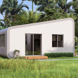 May include: A contemporary white prefabricated house with a sloping roof and curved edges. The building has large windows, a sliding glass door, and a small wooden deck. It is set in a tropical environment with green grass and palm trees.