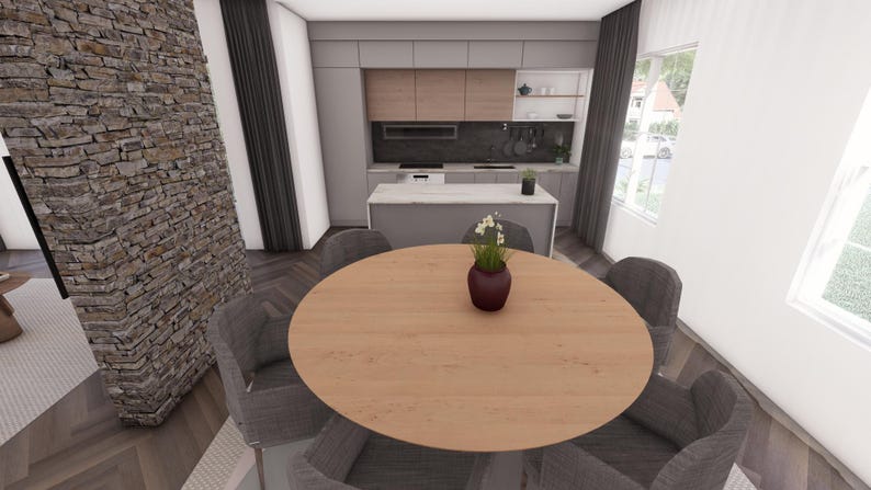 May include: Interior shot of a modern kitchen and dining area. A round wooden dining table is surrounded by four gray upholstered chairs. A small vase with flowers sits on the table. The kitchen features light wood cabinets and a gray island.