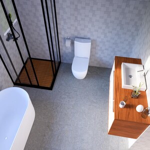 May include: A modern bathroom featuring a white bathtub, toilet, and sink. A black-framed shower and an oval mirror are also visible. The walls are tiled in a light grey pattern, and the floor is a matching grey.
