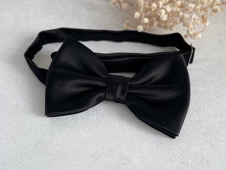 May include: A black satin bow tie with an adjustable strap.