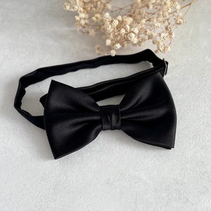 May include: A black satin bow tie with an adjustable strap.