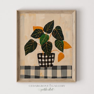 May include: A painting of a houseplant with green and yellow leaves in a black and white checkered pot. The plant is sitting on a black and white checkered tablecloth. The painting is framed in a light wood frame.