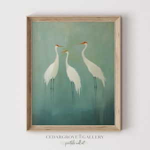 May include: A framed painting of three white birds with orange beaks standing on a blue and green background.