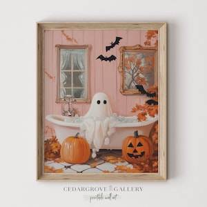 May include: A framed print depicts a ghost in a bathtub with bubbles, surrounded by pumpkins and autumn leaves. The artwork has a vintage aesthetic, with bats and a framed picture on the pink wall. The text "CEDARGROVE GALLERY printable wall art" is at the bottom.