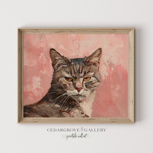 May include: A painting of a tabby cat with green eyes, looking directly at the viewer. The cat is painted in a realistic style with a soft, muted color palette. The background is a light pink.