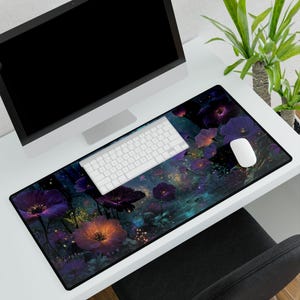 May include: A rectangular desk mat featuring a floral design with purple and orange flowers. A white keyboard and mouse sit on the mat, with a computer monitor in the background. The mat measures approximately 31.5 inches long and 11.8 inches wide.