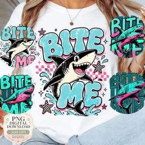 May include: White t-shirt with a cartoon shark design and the text "Bite Me" in a bubble font. The design incorporates water splashes, stars, and a checkered pattern. Additional shark graphics are placed around the central design.